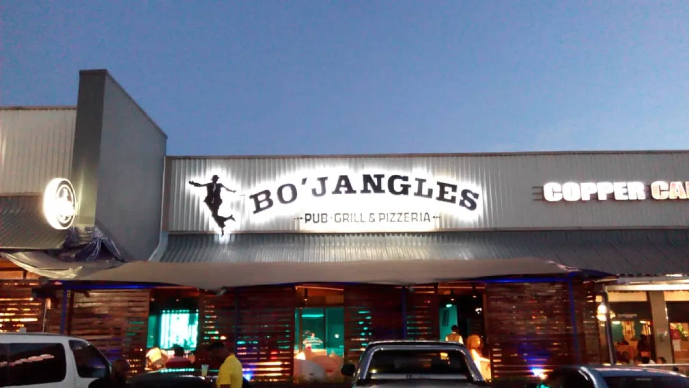 Bo’Jangles shopfront sign lit up at dusk